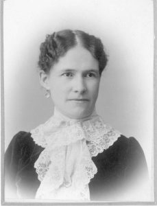 Black and white portrait of a white woman from the turn of the last century.