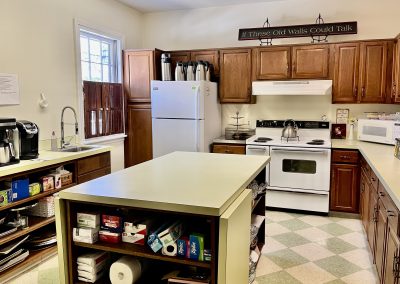 Kitchen with center island, electric stove and refrigerator